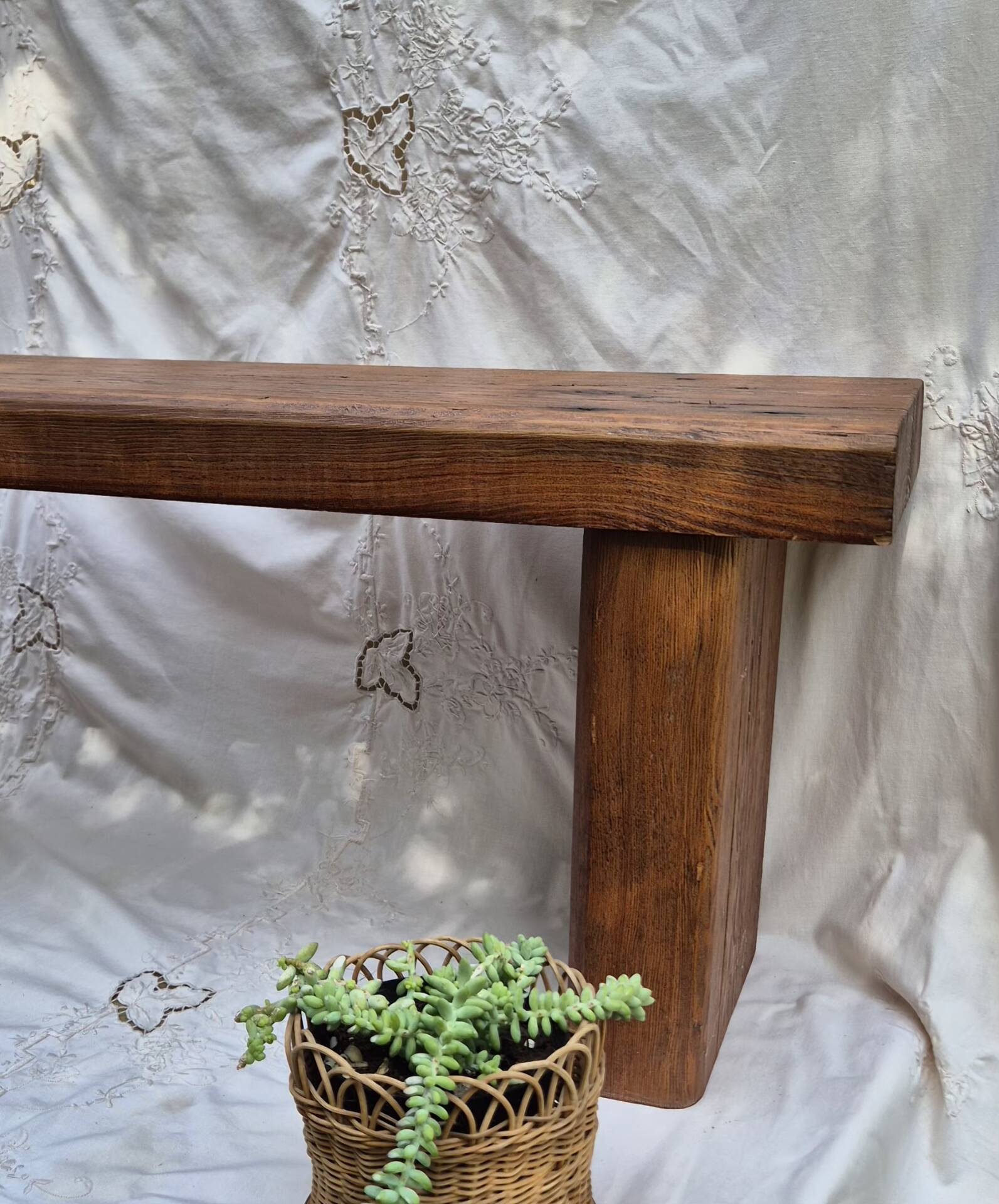 Brutalist wooden bench made of solid oak beam.