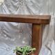 Brutalist wooden bench made of solid oak beam.