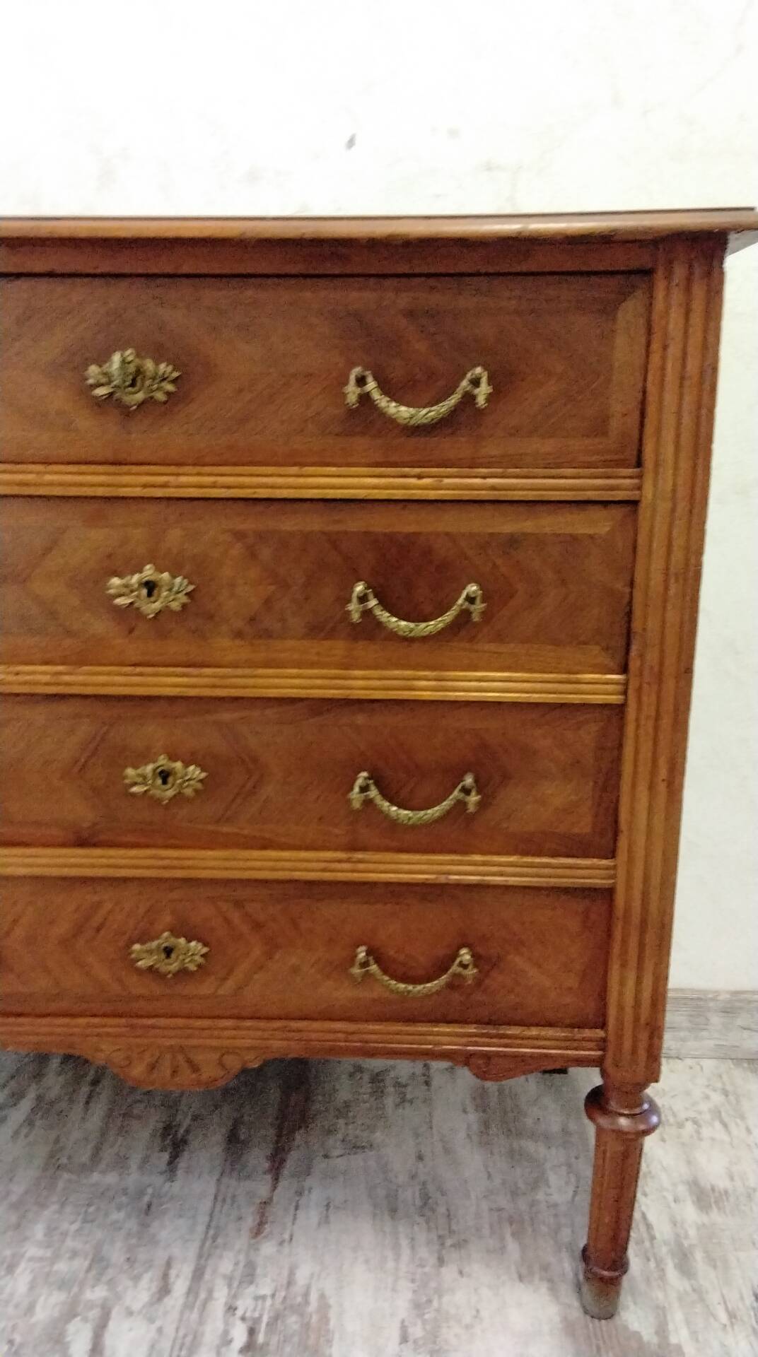 Antique marquetry commode in the Louis XVI style.