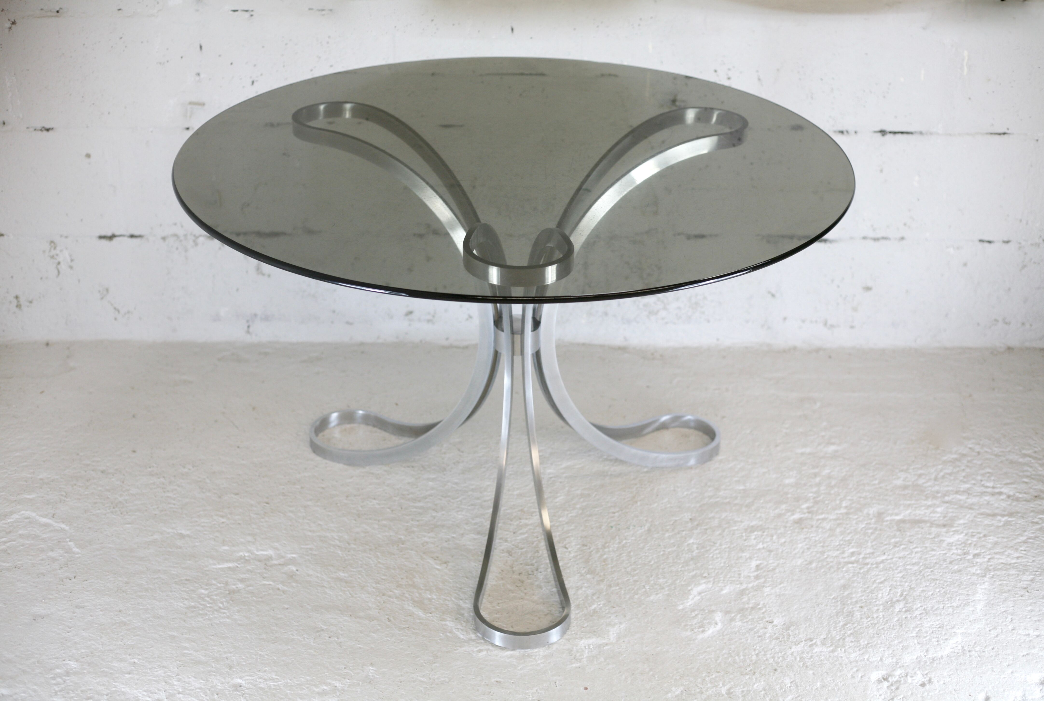 Living room table "Space Age" polished steel, circular slab smoked glass. France, circa 1970.