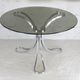 Table de séjour "Space Age" acier poli, dalle circulaire verre fumé. France, circa 1970.