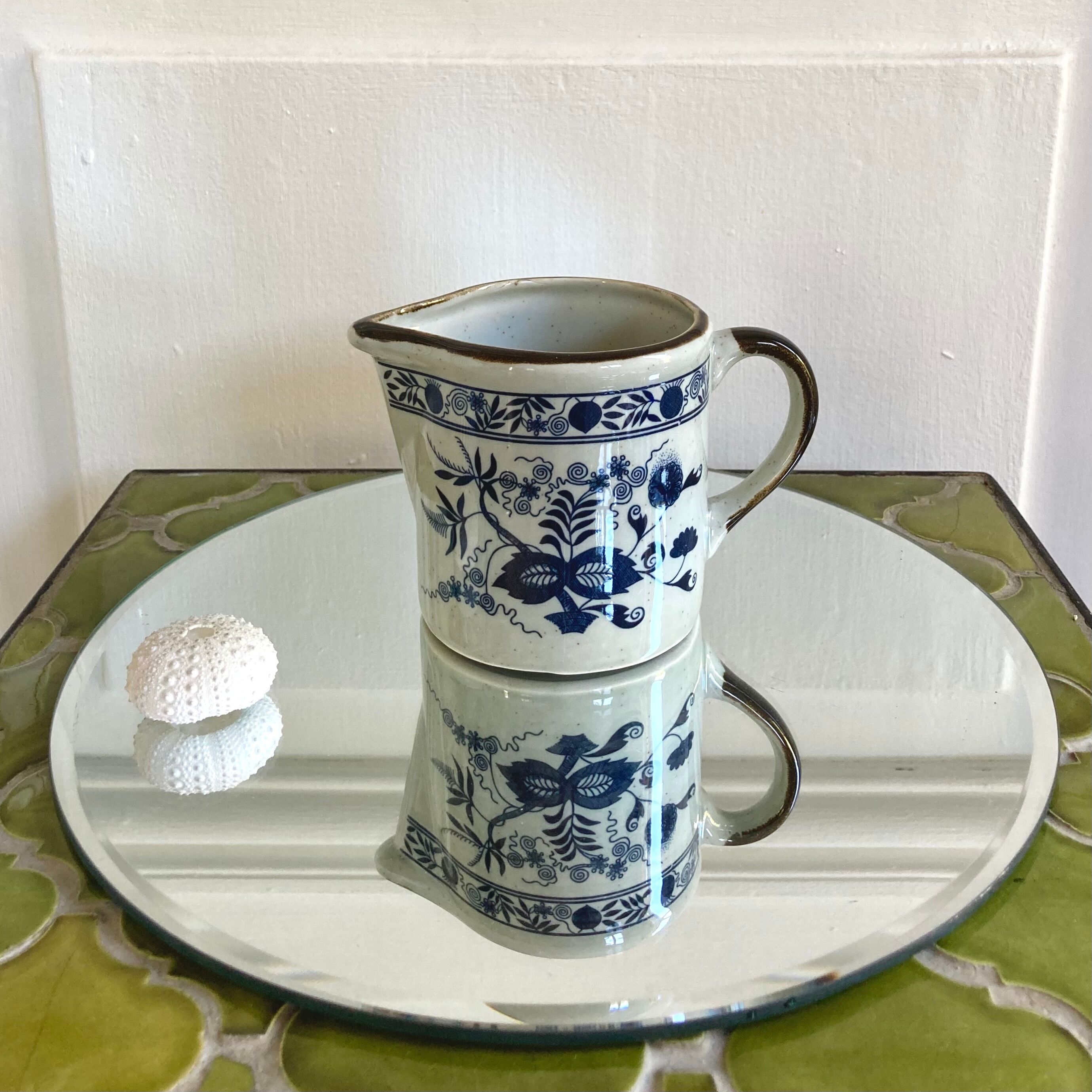Stoneware milk jug with flower decoration