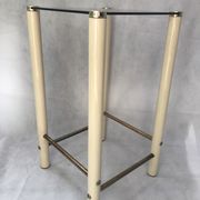 Square side table in metal and smoked glass.