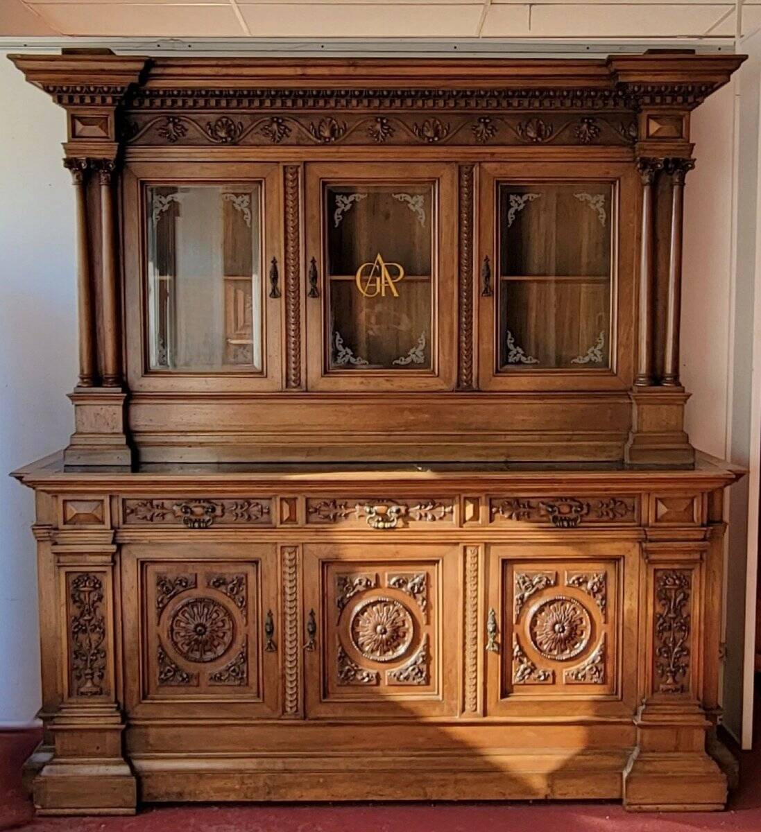 Two-body buffet, made of richly carved solid walnut.