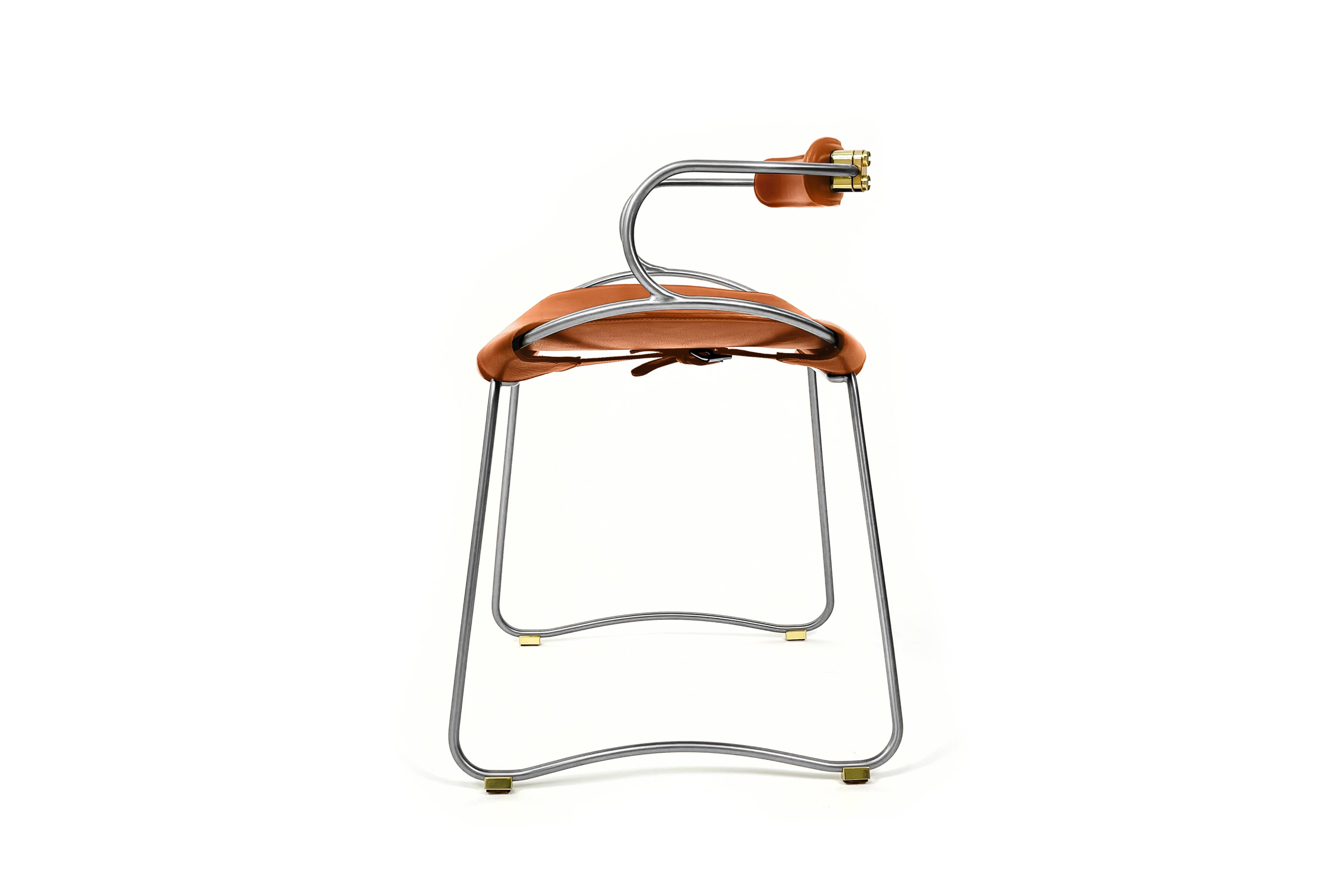Table height stool with a backrest in aged silver metal and natural tan leather.