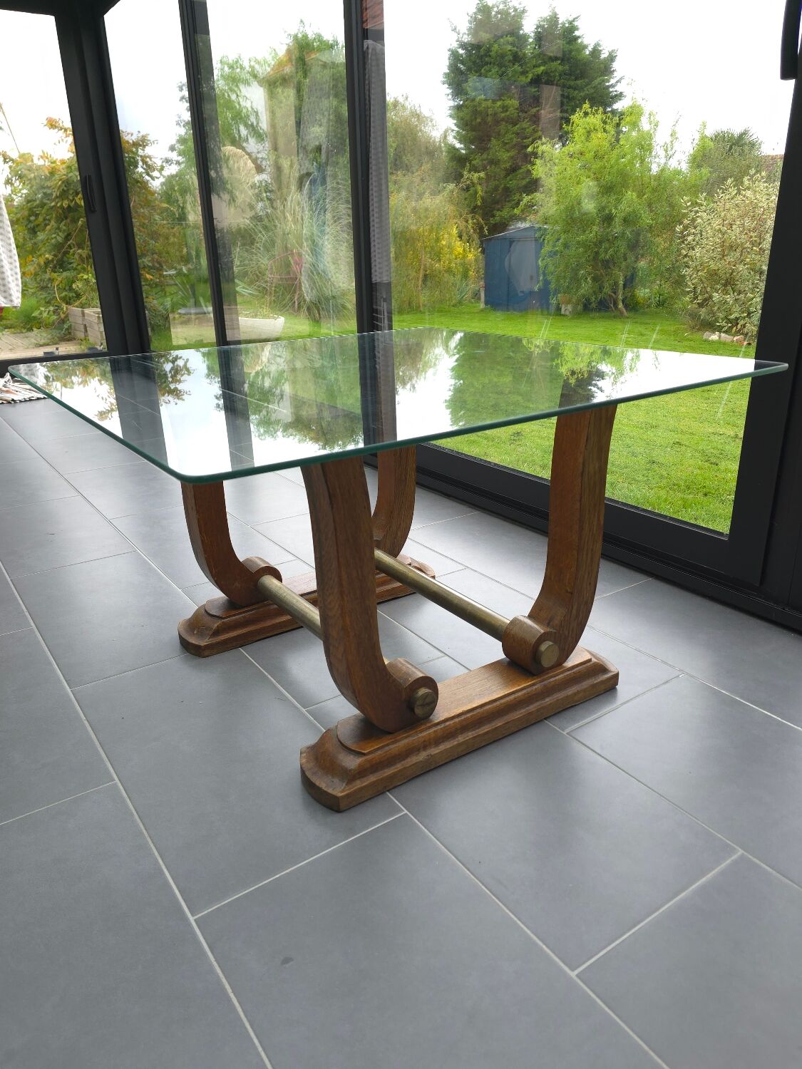 Art Deco coffee table in glass, wood, and brass.