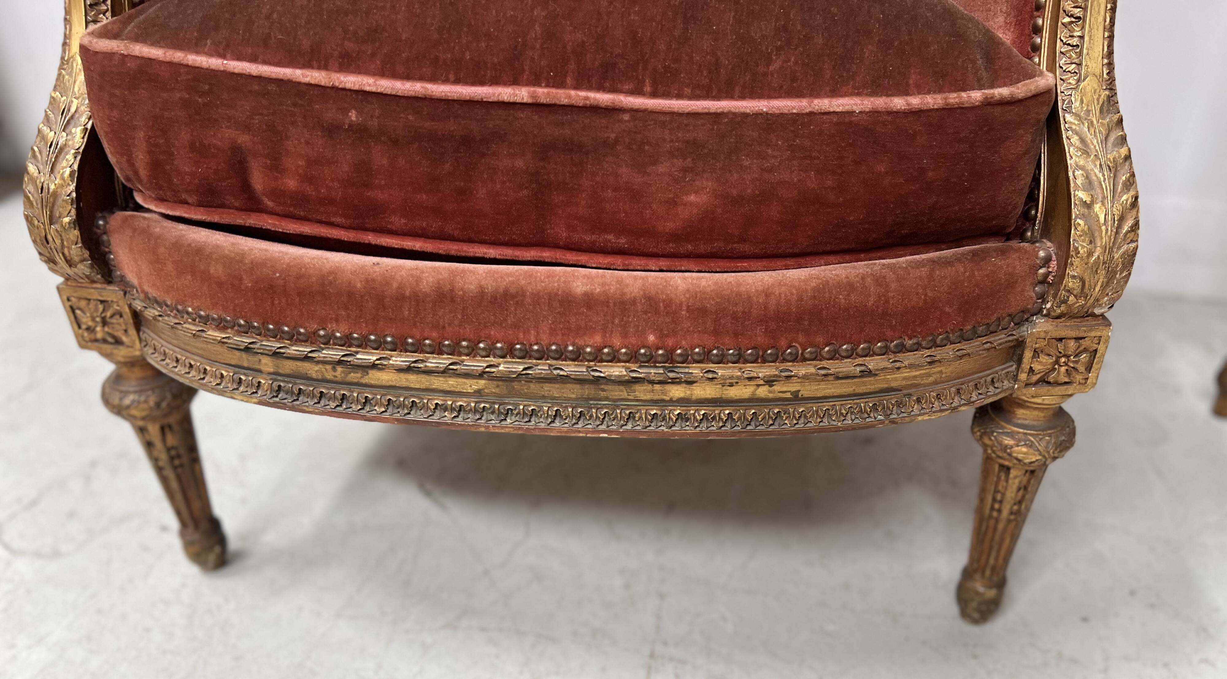 Two Louis XVI style wing chairs in gilded wood, 20th century