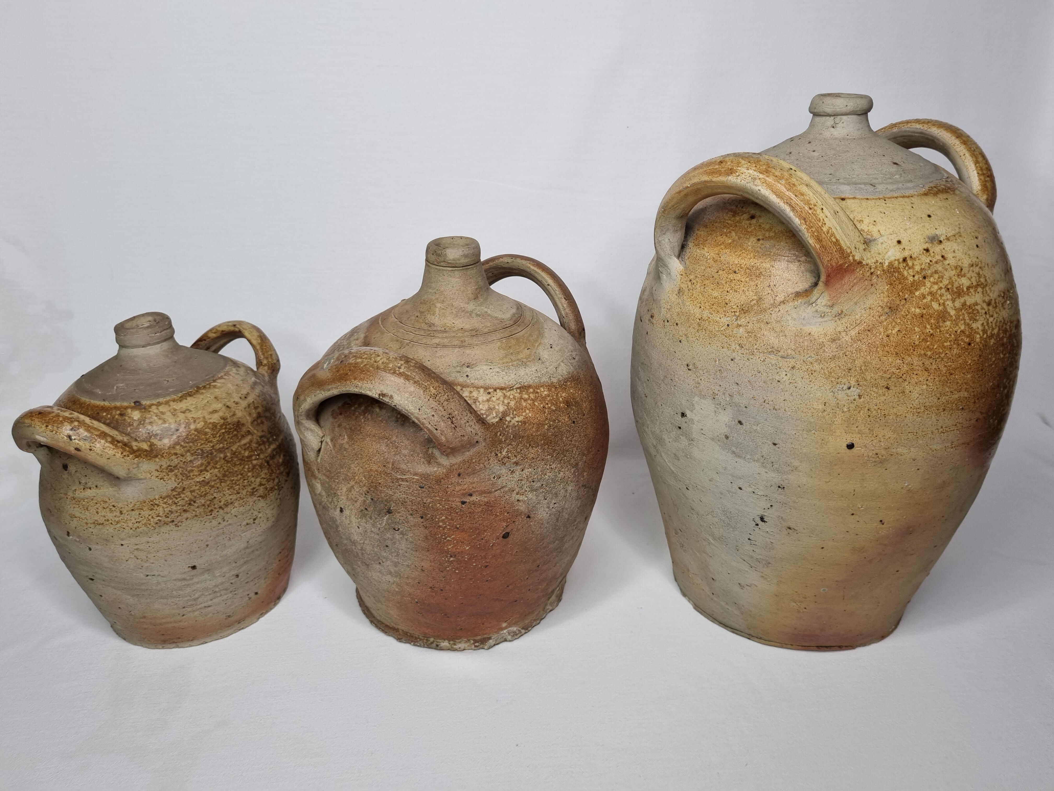 Set of three ancient ladies-jeannes in enamelled terracotta