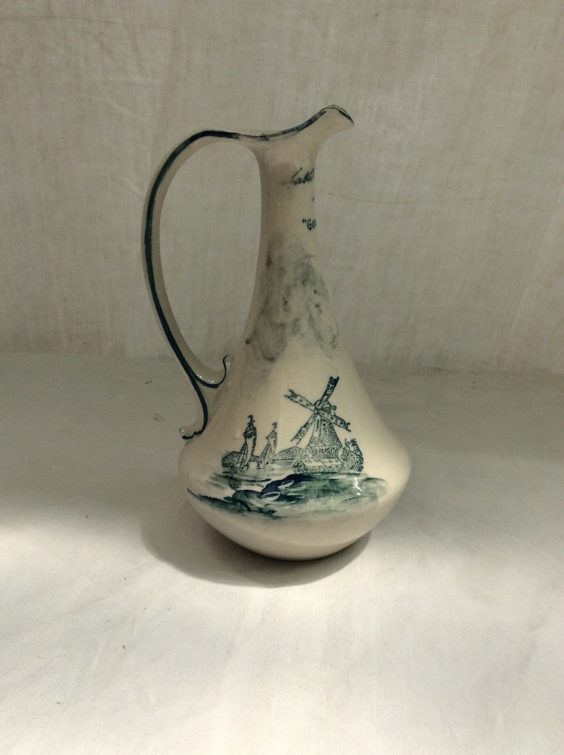 Old pitcher in Dutch-made earthenware signed