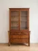 Antique wooden storage cabinet with display case.
