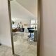 Textured embossed metal wall mirror with bevelled mirror.