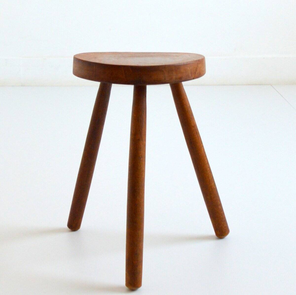Old brutalist tripod stool in solid wood