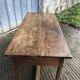 Old chestnut table with 3 front drawers and a cat bar.