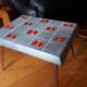 Small 1960s enamelled table, spindle legs, signed jd.