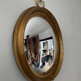 Vintage witch's eye mirror in gilded wood