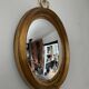 Miroir œil de sorcière vintage en bois doré
