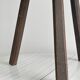 Antique wooden tripod stool with a semi-circular seat.