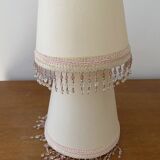 2 off-white fabric lampshades with pink and white tassels