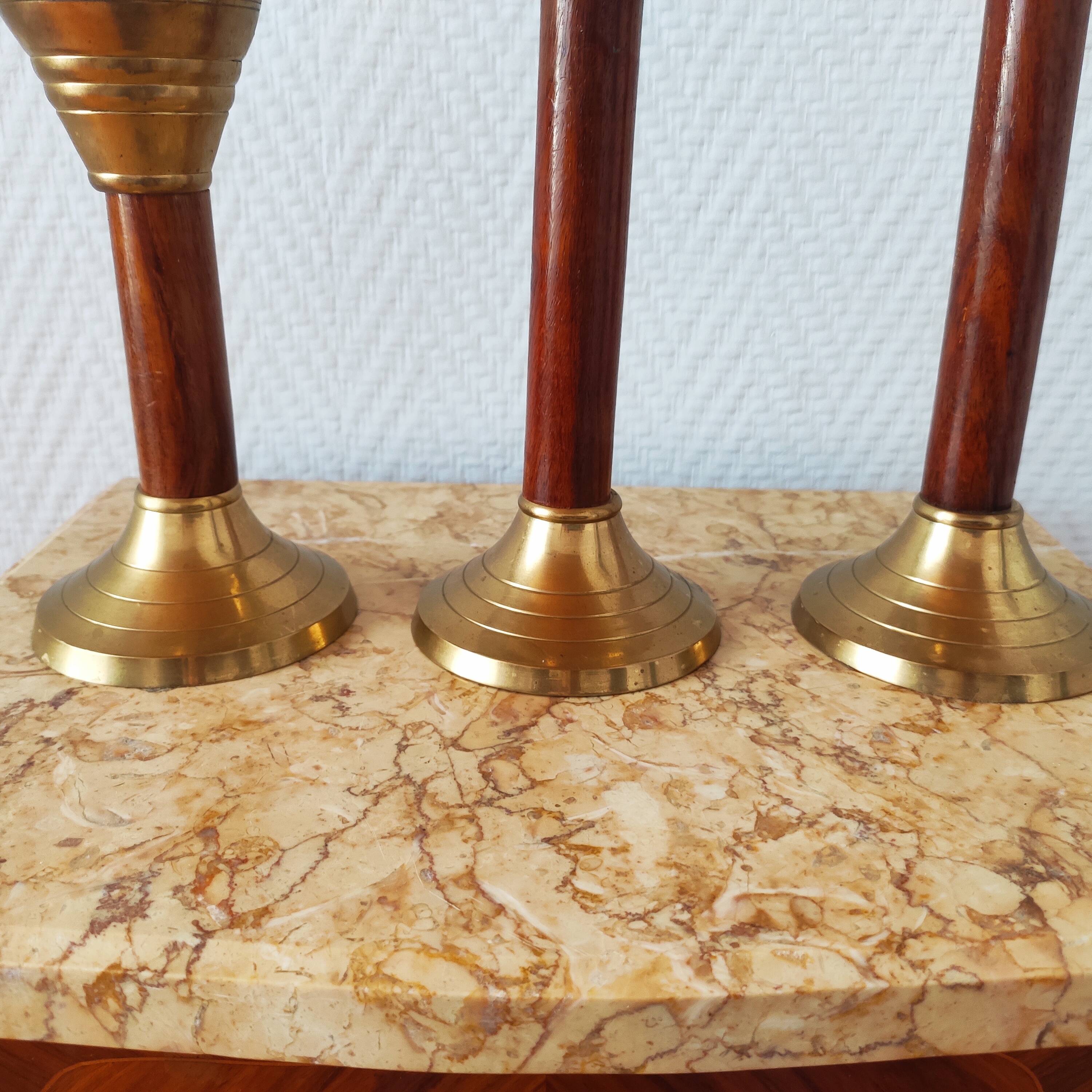 Set of three vintage wooden and brass candlesticks
