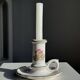 Small vintage hand-held candlestick in earthenware with green trim and floral decoration H10.5