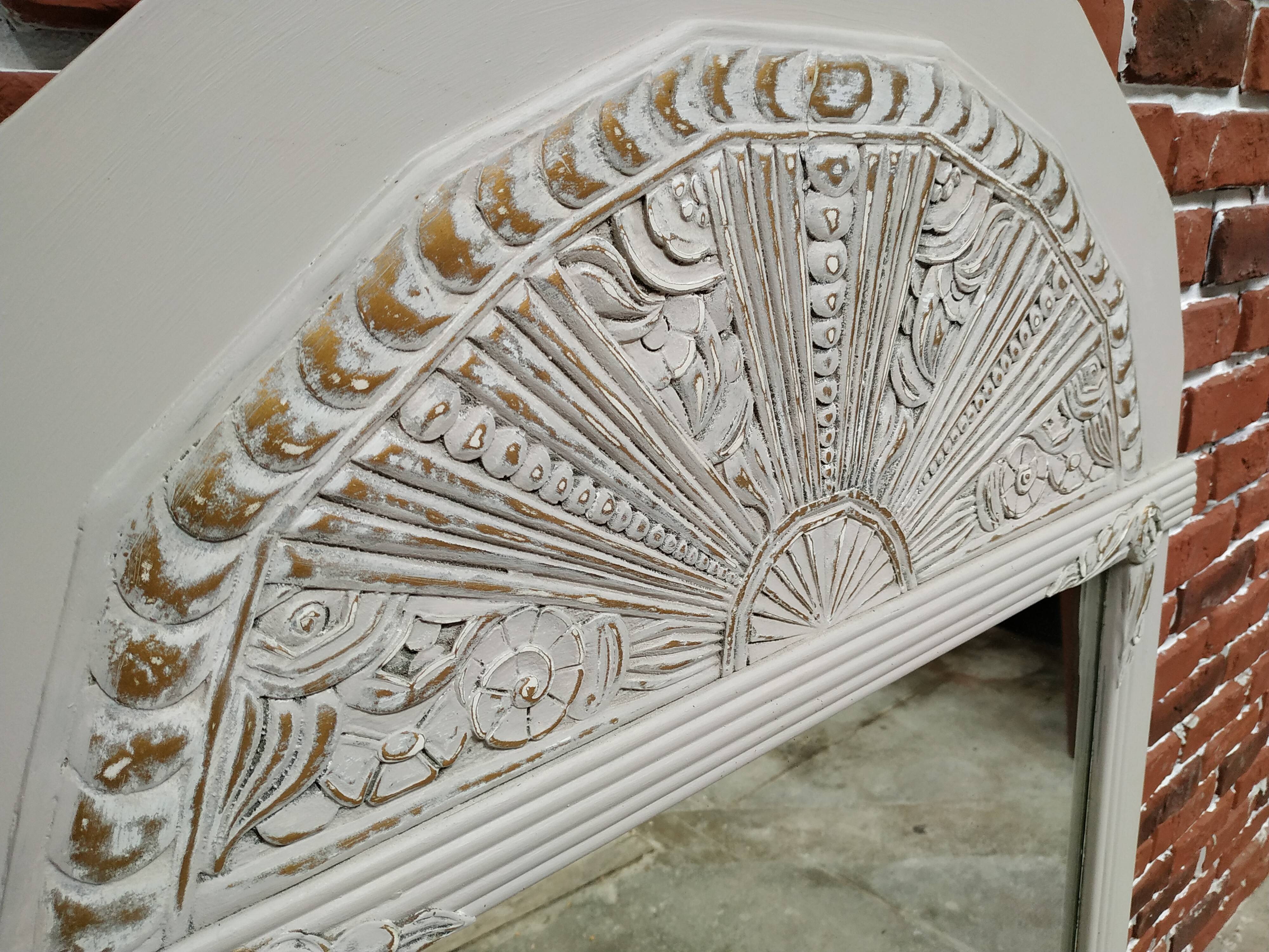 White and gold patinated sculpted mirror