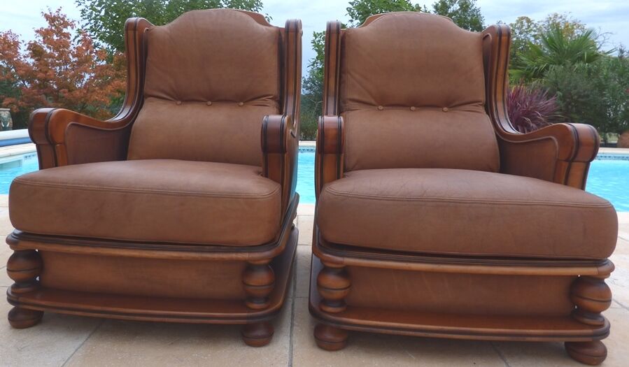 Pair of aged leather armchairs with seat and firm backrest with cherry wood frame
