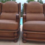 Pair of aged leather armchairs with seat and firm backrest with cherry wood frame