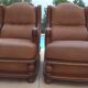 Pair of aged leather armchairs with seat and firm backrest with cherry wood frame