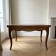 Extendable dining table in Louis XV style made of wood.