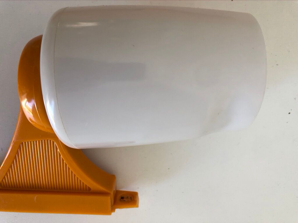 Tiltable orange plastic mirror with matching wall light