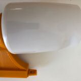 Tilting orange plastic mirror with its matching wall light