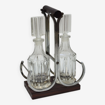 Elegant glass oil and vinegar condiment service, metal wood support