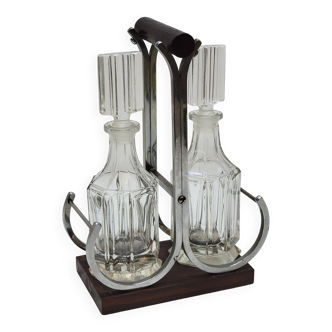 Elegant glass oil and vinegar condiment service, metal wood support
