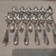 12 silver-plated dessert spoons with rocaille ribbon decoration, 18.5 cm