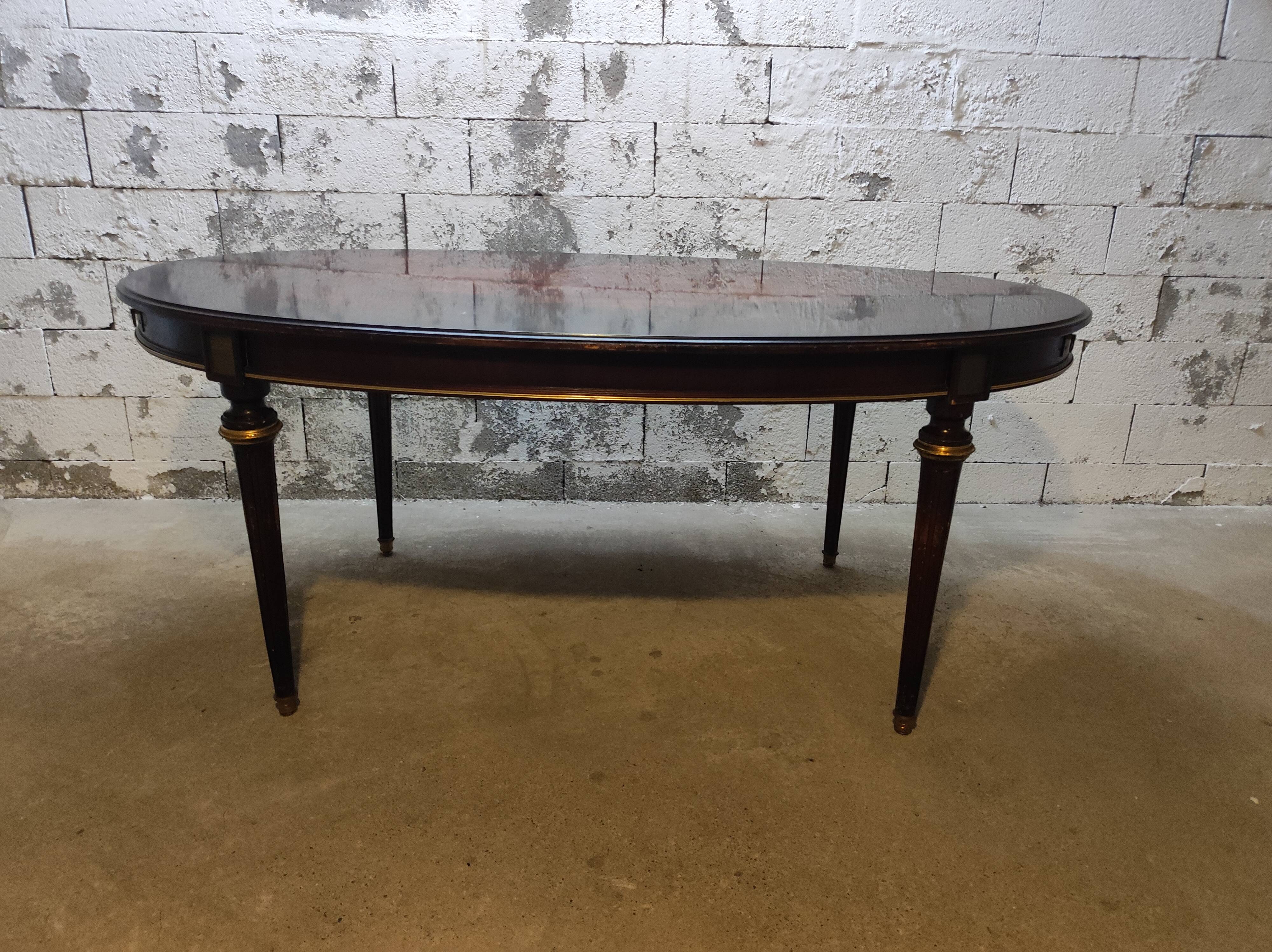 Oval Louis XVI style table with half-moon extensions.