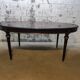 Oval Louis XVI style table with half-moon extensions.