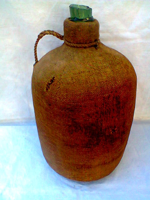 Demijohn dressed in burlap and padded cork