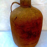 Demijohn dressed in burlap and padded cork