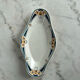 Longwy ramekin with blue and orange floral decoration.
