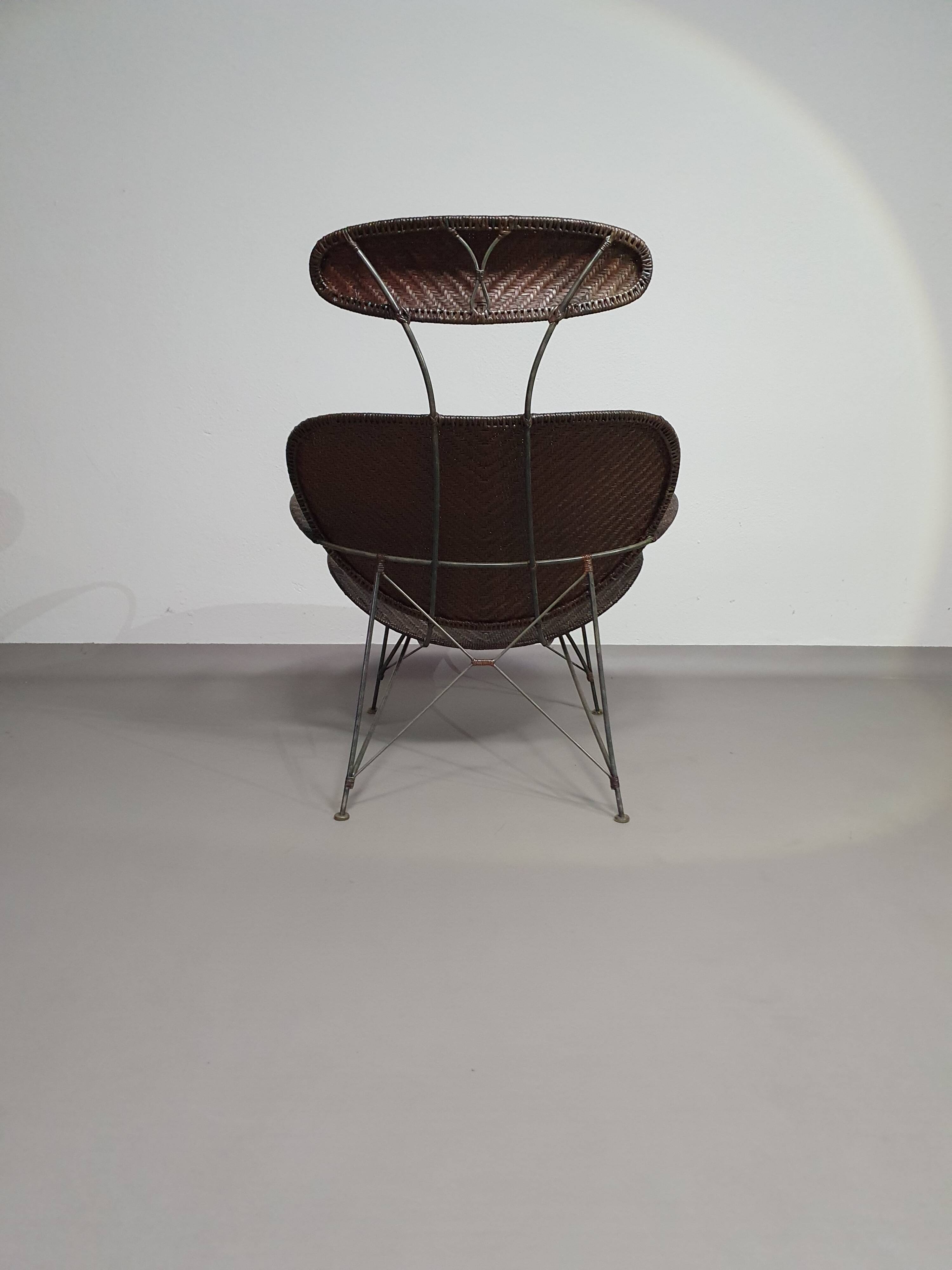 Armchair designed by Yuzuru Yamakawa  Metal frame.  Seat and back in braided rattan.