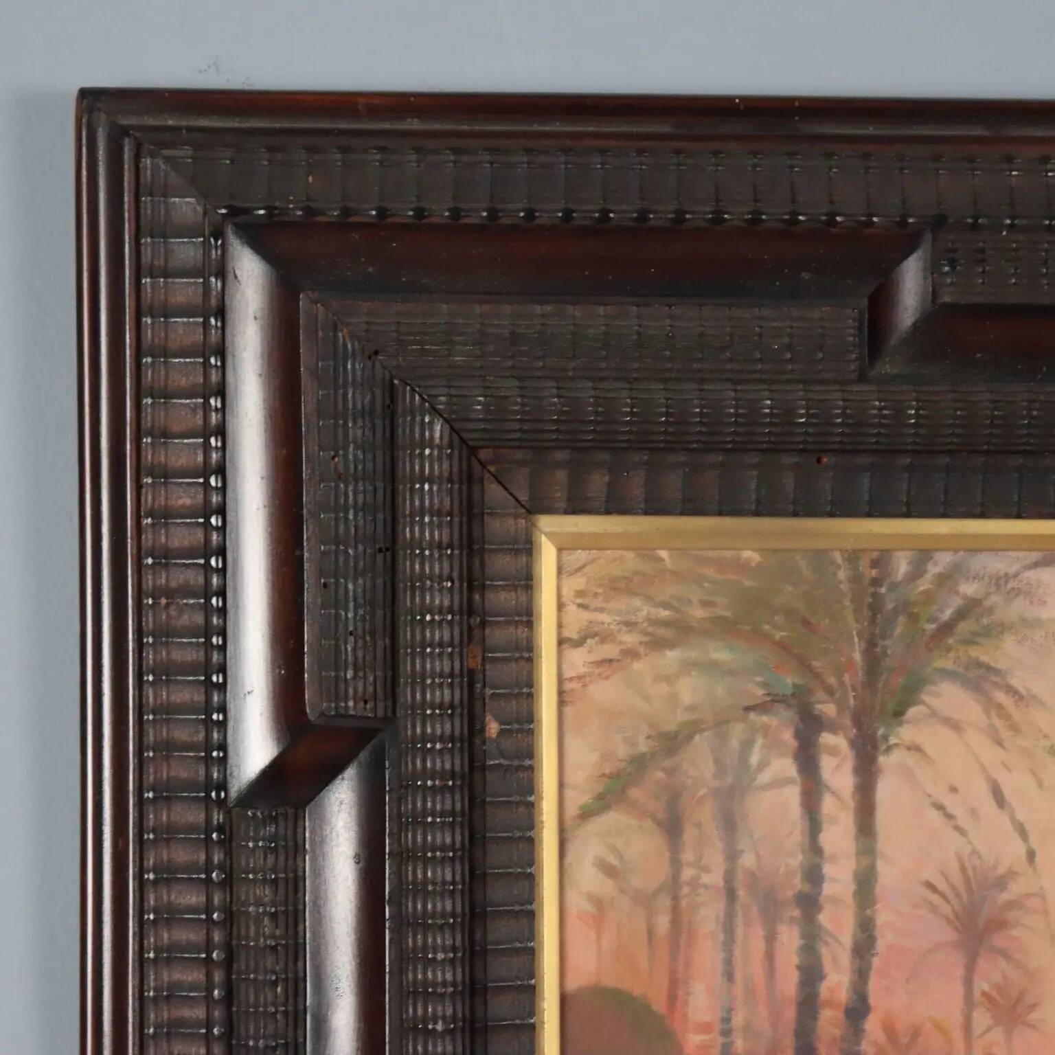 Ancient painting of an exotic landscape with pyramids and figures from the 1800s.