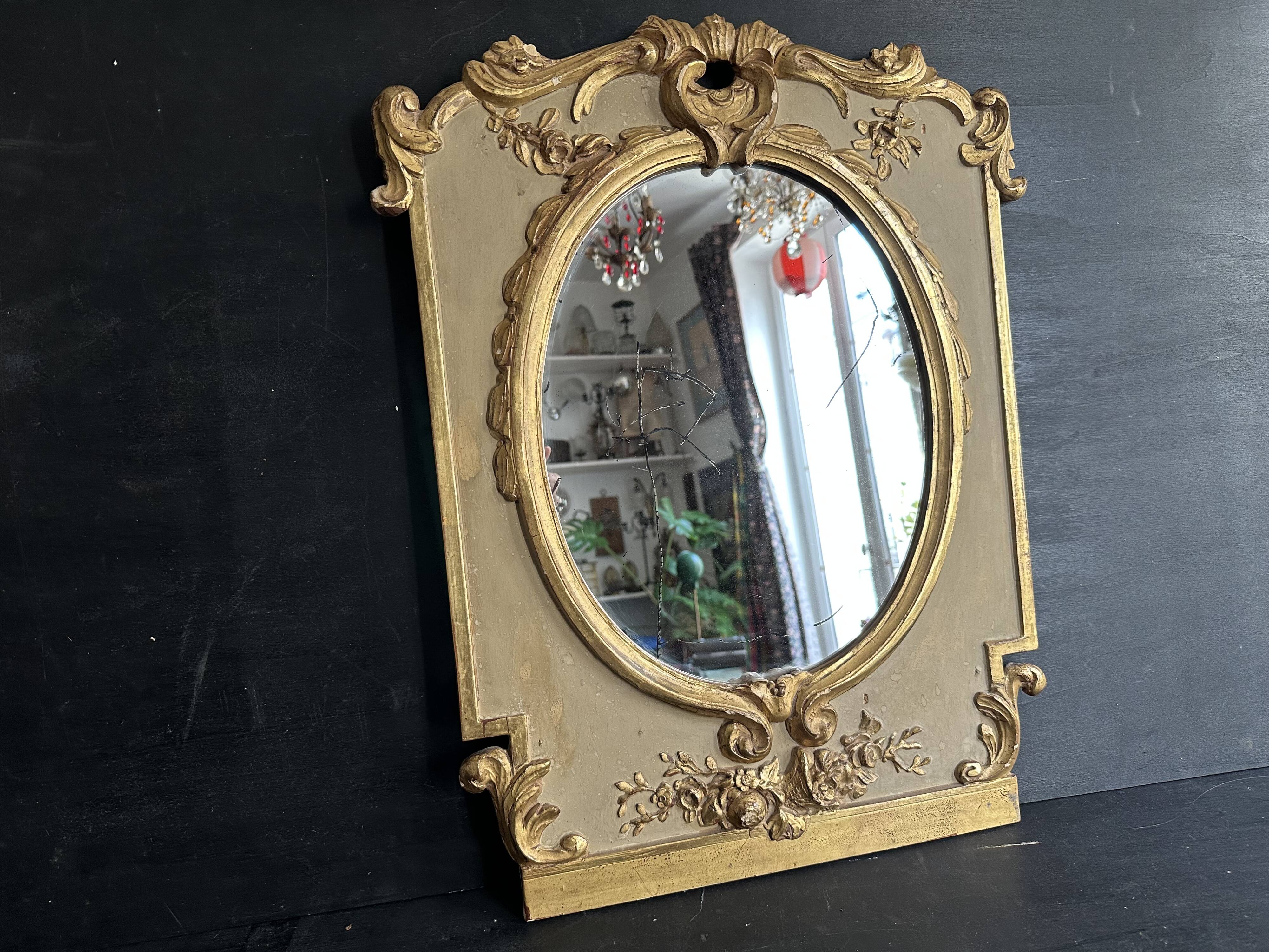 Napoleon III mirror in carved gilded wood, oval mercury glass.