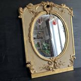 Napoleon III mirror in carved gilded wood, oval mercury glass.