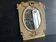 Napoleon III mirror in carved gilded wood, oval mercury glass.