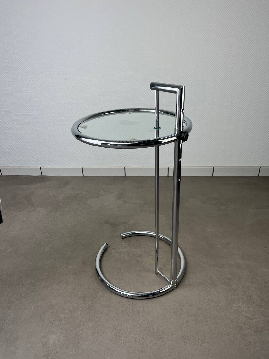 Chrome and glass design side table, adjustable.