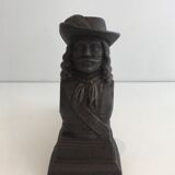 Pair of cast iron andirons in the likeness of a musketeer