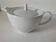Graphic teapot in white porcelain with a minimalist design.