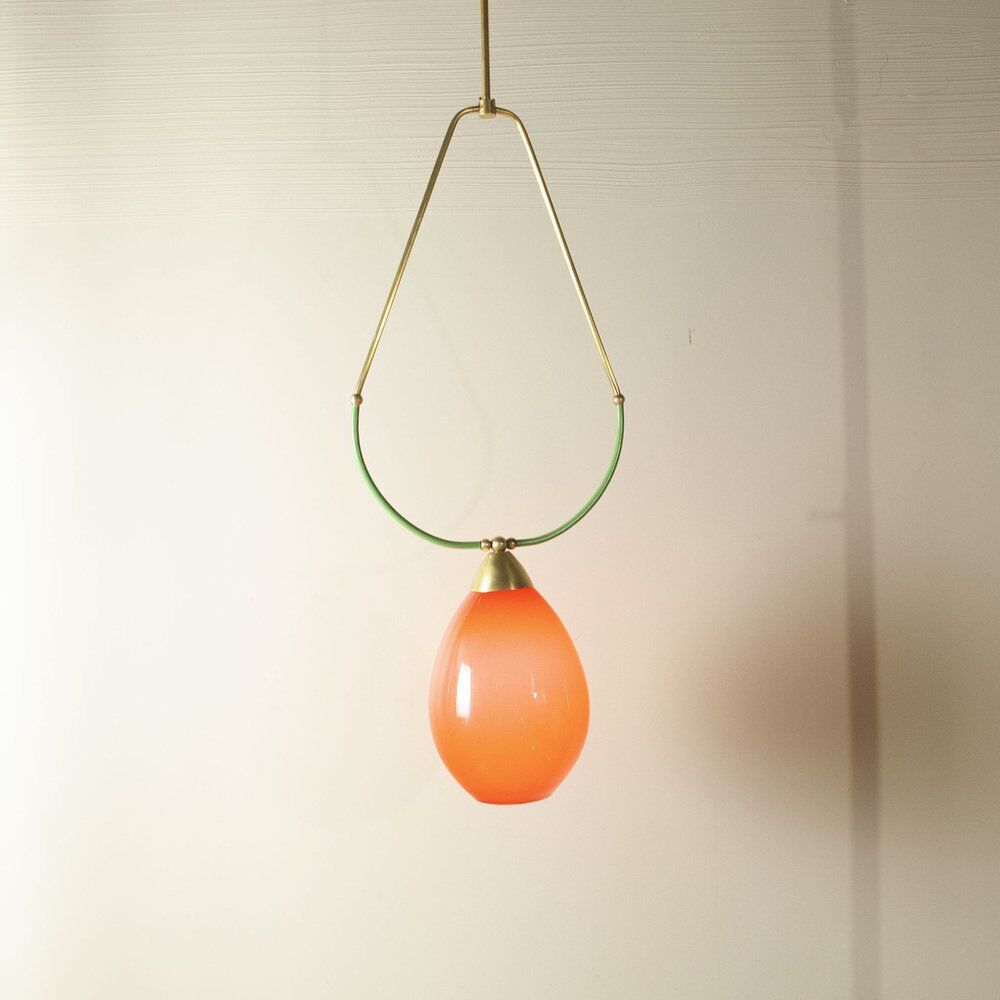Hanging lamp with a brass frame in the shape of scales and a red-purple Murano glass diffuser.