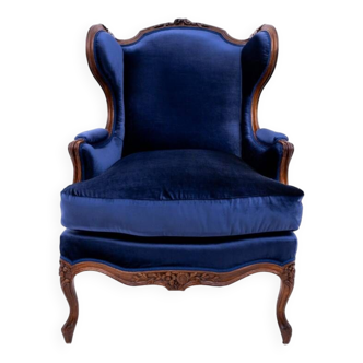 Winged navy blue armchair, France, circa 1910.