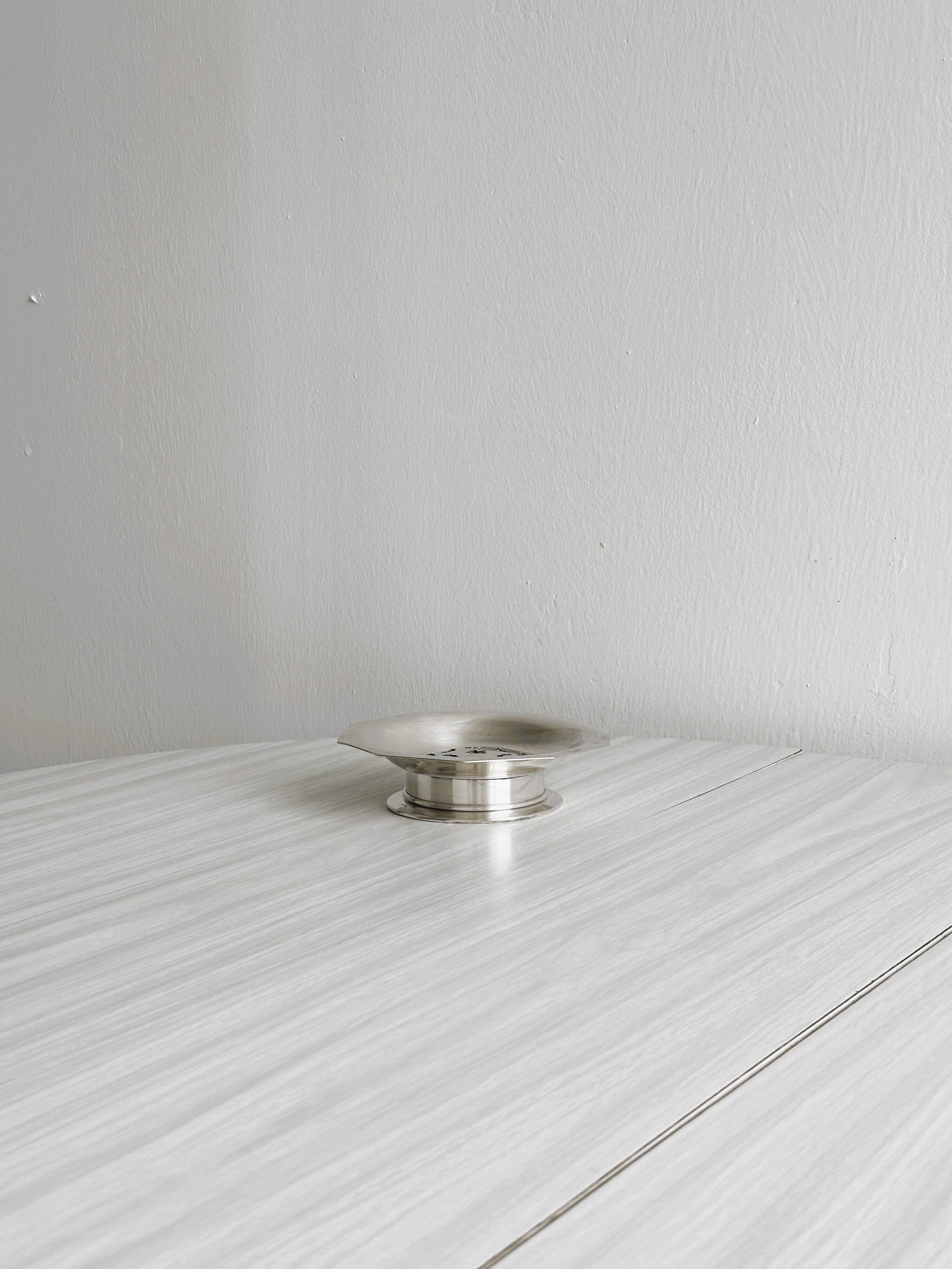 Antique butter dish in shiny metal